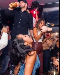 Bounce NYC Bottle Service Table pouring drink into girls mouth Reservations at Always The VIP