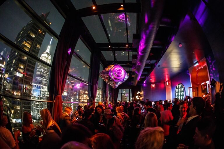 The Fleur Room NYC in Moxy Chelsea The North Room during nightlife with a full dance floor and view of The Empire State Building VIP Reservations at Always The VIP